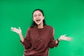 young Asian woman expressing happy wide-open mouth looking to the camera while causing the palms to rise open