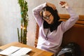 Young asian woman writing down notes while drinking coffee Royalty Free Stock Photo