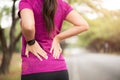 Young asian woman feel pain on her back and hip while exercising, health care concept