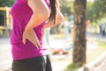 Young asian woman feel pain on her back and hip while exercising Royalty Free Stock Photo