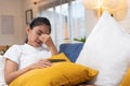 Young asian woman feeling  stress  and closed eyes  suffering from headache and lying down on sofa in living room,tired  female of Royalty Free Stock Photo