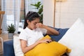 Young asian woman feeling  stress  and closed eyes ,she is  suffering from headachelying down on sofa in living room,tired  female Royalty Free Stock Photo