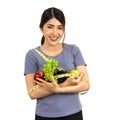 Young asian woman in fitness clothes holding fruits with measuring tape. Portrait on white background with studio light. Healthy Royalty Free Stock Photo