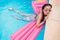 Young asian woman floating on inflatable mattress Royalty Free Stock Photo