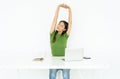 Young Asian woman freelancer in casual clothing are stretch hands with eyes closed for relaxation on her desk, relaxing enjoying Royalty Free Stock Photo