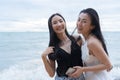 Young Asian woman friends on vacation at the beach.