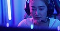 Young Asian woman gamer having live stream and playing in Online Video Game.