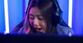 Young asian woman gamer having live stream and playing in online video game.