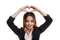 Young Asian woman gesturing heart hand sign. Royalty Free Stock Photo