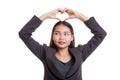 Young Asian woman gesturing heart hand sign. Royalty Free Stock Photo