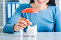 Young asian woman hand hold umbrella toy to protect the home and money for saving money and house and real estate property