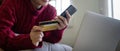 Young Asian woman hands holding credit card and using smartphone for internet purchase. Online shopping, Online payment Royalty Free Stock Photo