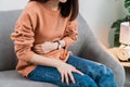 Young Asian woman hands holding the stomach and pain period cramps because having menstruation. Royalty Free Stock Photo