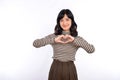 Young asian woman hands making a heart shape on a white isolated background Royalty Free Stock Photo