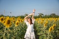 Young asian woman happiness and raising arms on sunflower field in countryside Royalty Free Stock Photo