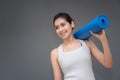 Young asian woman with happy smile holding her yoga mat Royalty Free Stock Photo