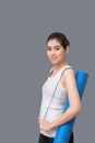 Young asian woman with happy smile holding her yoga mat Royalty Free Stock Photo