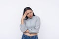 A young asian woman has an excruciating headache. Feeling a bad migraine. Isolated on a white background