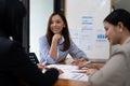 A young asian woman is having a business meeting with her team colleagues in a conference room. Royalty Free Stock Photo