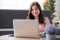 Young asian woman having conversation chatting while using laptop at house. Work at home, Video conference, Online Royalty Free Stock Photo