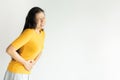 Young asian woman having painful stomachache on white background.Chronic gastritis. Abdomen bloating concept