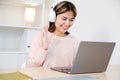 Young asian woman with headphones while make video conference by laptop computer Royalty Free Stock Photo