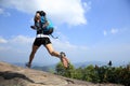 Young asian woman hiker running on mountain peak Royalty Free Stock Photo
