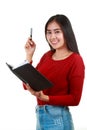 Young Asian woman holding book and taking note with smiling to camre Royalty Free Stock Photo