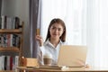 Young Asian woman holding credit card and thinking of online shopping in internet, happy and relax Royalty Free Stock Photo