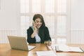 Young asian woman holding credit card and using smart phone for purchase product on internet in home office. Online shopping Royalty Free Stock Photo