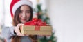 Young Asian woman holding gift box, with smiling face. Christmas gift Royalty Free Stock Photo