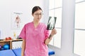 Young asian woman holding hand xray at physiotherapy clinic