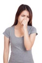 Young Asian woman holding her nose because of a bad smell Royalty Free Stock Photo