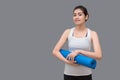 Young asian woman holding her yoga mat at healthy sport gym. Yoga and meditation have good benefits for health. Photo concept for Royalty Free Stock Photo