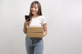 Young asian woman holding paper box and cardbord box over white background, Save earth and delivery concept Royalty Free Stock Photo