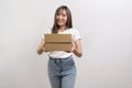 Young asian woman holding paper box and cardbord box over white background, Save earth and delivery concept Royalty Free Stock Photo