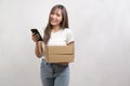 Young asian woman holding paper box and cardbord box over white background, Save earth and delivery concept Royalty Free Stock Photo