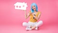 Portrait of a pretty excited asian girl with colorful shopping bags showing  isolated over pink background .Asian shopaholic woman Royalty Free Stock Photo