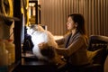 Young Asian woman holding pet cat while working from home Royalty Free Stock Photo