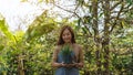 A young woman holding and preparing to plant rosemary tree for home gardening concept Royalty Free Stock Photo