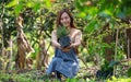 A young woman holding and preparing to plant rosemary tree for home gardening concept Royalty Free Stock Photo