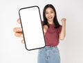 Young Asian woman holding smartphone with blank screen for advertise on white background