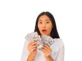 Young Asian woman holding a 100 us dollar money in hand Royalty Free Stock Photo