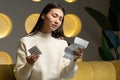 Young Asian woman holds a blister pack of pills and reads medical instructions Royalty Free Stock Photo