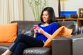 Young asian woman at home on the sofa