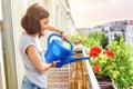 Young Asian Woman housewife Watering flowers On Balcony Royalty Free Stock Photo