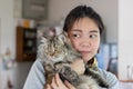 Young Asian woman is hugging a persian cat with indoor scene Royalty Free Stock Photo