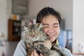 Young Asian woman is hugging a persian cat with indoor scene Royalty Free Stock Photo