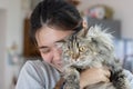 Young Asian woman is hugging a persian cat with indoor scene Royalty Free Stock Photo