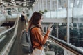 Young asian woman in international airport terminal or modern train station Royalty Free Stock Photo